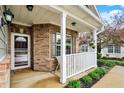 Inviting front porch with white railing, decorative plants, and a cozy welcome mat at 661 Overcup St, Westfield, IN 46074