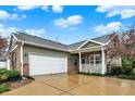 Spacious two-car garage with brick accents, complementing the home's exterior and well-kept landscaping at 661 Overcup St, Westfield, IN 46074