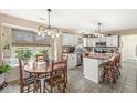 Bright kitchen with a breakfast nook, white cabinets, a mosaic backsplash, and an island with seating at 719 Hohlier Ln, Avon, IN 46123