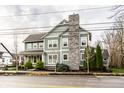Charming home featuring two stories, a prominent stone chimney, and manicured landscaping at 768 Trailside Dr, Carmel, IN 46032