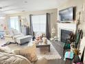 Cozy living room with fireplace, large screen television, and comfortable furnishings at 7916 Begonia Ct, Indianapolis, IN 46113