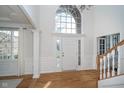 Bright foyer with large windows, hardwood floors, and elegant trim offering a warm welcome at 9880 Wading Crane Ave, Fishers, IN 46055