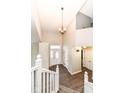 Inviting foyer with hardwood floors, pendant lighting, and staircase to the second floor at 10516 Beacon Ln, Indianapolis, IN 46256