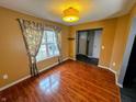 Bright dining room with beautiful wood floors, large window, and stylish light fixture at 10711 Regis Ct, Indianapolis, IN 46239