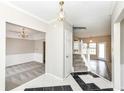 Inviting foyer with black and white tile floors leads to the living spaces and staircase with white railing at 10944 Echo Trl, Indianapolis, IN 46236