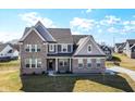 Charming two-story home with brick accents and a well-maintained front yard at 11392 Gammel Pl, Fishers, IN 46040
