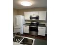 Kitchen with stainless steel appliances, white cabinets, and hardwood floors at 11876 Wapiti Way, Noblesville, IN 46060