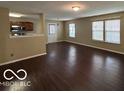 Bright living room with hardwood floors and multiple windows for natural light at 11876 Wapiti Way, Noblesville, IN 46060
