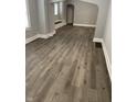 A bright, open-concept space featuring hardwood floors and neutral wall paint at 1216 N Holmes Ave, Indianapolis, IN 46222
