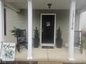Inviting covered front porch with rocking chairs, decorative plants, and charming welcome decor creates a cozy entrance at 13124 S Elster Way, Fishers, IN 46037