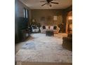 Spacious living room with a cozy seating arrangement, ceiling fan, and a decorative rug creating a comfortable atmosphere at 13124 S Elster Way, Fishers, IN 46037
