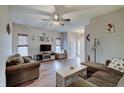 Spacious living room with ceiling fan, wood flooring and neutral paint at 15433 Wandering Way, Noblesville, IN 46060