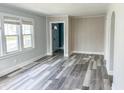 Inviting living area with new flooring, large window, and neutral paint, ready for personal touches at 1627 E 8Th St, Anderson, IN 46012