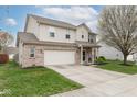 Two-story home with brick and siding, two-car garage, and a well-maintained lawn on a sunny day at 16963 Southall Dr, Westfield, IN 46074