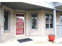 Inviting front entrance with brick facade, a charming porch, and windows offering natural light at 1915 Barbie Ct, Franklin, IN 46131