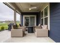 Relaxing covered patio with comfortable seating and a modern ceiling fan at 19668 Mcdonald Pl, Westfield, IN 46074