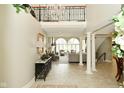 Inviting foyer with grand staircase, soaring ceilings, wrought iron details, and elegant decor at 2004 Caledonian Ct, Greenwood, IN 46143