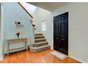 Bright foyer with hardwood floors, staircase, and a stylish entryway table at 20107 Marie Ct, Noblesville, IN 46062