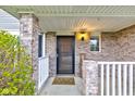 Inviting front porch with brick accents, covered entryway, and decorative welcome mat at 20107 Marie Ct, Noblesville, IN 46062