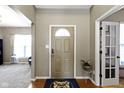 Welcoming entryway with hardwood floors, neutral paint, and decorative rug at 203 Winslow Dr, Westfield, IN 46074