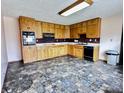 Functional kitchen with wooden cabinets, modern appliances, and tile flooring at 204 W Berry St, Alexandria, IN 46001