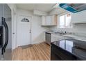 Bright kitchen featuring stainless steel appliances, white cabinets, a modern sink, and wood-look flooring at 2134 Dawson St, Indianapolis, IN 46203