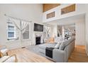 Bright living room features soaring ceilings, fireplace, hardwood floors and expansive windows at 2349 N Delaware St, Indianapolis, IN 46205