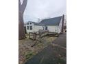 This house features an aging wooden deck and walkway and an exterior in need of maintenance at 2612 Mcleay Dr, Indianapolis, IN 46220