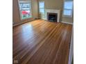 Bright living room with hardwood floors, a fireplace, and natural light from large windows at 2612 Mcleay Dr, Indianapolis, IN 46220