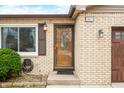 Close-up of the brick home's front door with decorative glass, complemented by stylish outdoor lighting at 301 Lancelot Dr, Franklin, IN 46131