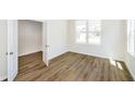 Bright bedroom features wood-look flooring, ample natural light from a large window, and a neutral color palette at 3241 Fawn Cir, Brownsburg, IN 46112