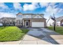 Beautiful home with a basketball hoop, a paved driveway, and a green lawn under a blue sky at 3341 Suffolk Ct, Greenwood, IN 46143