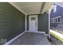 Covered porch features sleek white trim, new siding, and updated front door at 337 E Minnesota St, Indianapolis, IN 46225