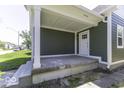 Covered porch features sleek white trim, new siding, and updated front door at 337 E Minnesota St, Indianapolis, IN 46225