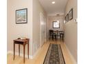 Inviting hallway with wood floors, neutral paint, table decor and an adjacent dining area at 350 N Meridian St # 205, Indianapolis, IN 46204