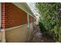 The side of this brick home is surrounded by lush greenery at 3510 Chamberlin Dr, Indianapolis, IN 46237
