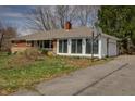 Single story home featuring a driveway with basketball hoop and attached garage at 3510 Chamberlin Dr, Indianapolis, IN 46237