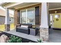 Inviting covered front porch featuring stone columns, bench seating, and stylish decor for a welcoming entrance at 3849 Sun Valley Dr, Westfield, IN 46074