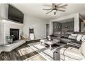 Open concept living room with a fireplace, plush sofa, and lots of natural light at 3849 Sun Valley Dr, Westfield, IN 46074