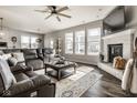 Bright living room featuring a stone fireplace, large windows, and a comfortable sectional sofa at 3849 Sun Valley Dr, Westfield, IN 46074