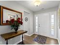 Spacious foyer with hardwood floors, a mirror, and a stylish entry table at 3856 Cornwallis Ln, Carmel, IN 46032