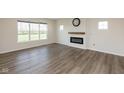 Inviting living room with hardwood floors, fireplace, and lots of natural light from the large windows at 4016 Railhead Ave, Westfield, IN 46074