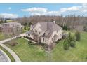 Aerial view of a large home with lush lawn and trees, close to neighboring homes in a suburban setting at 4429 Serengeti Cir, Carmel, IN 46074