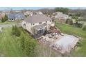 Aerial view of a backyard with a covered patio, outdoor kitchen, firepit, and covered pool at 4429 Serengeti Cir, Carmel, IN 46074