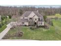 Aerial view of a lovely brick home with manicured front lawn and professional landscaping at 4429 Serengeti Cir, Carmel, IN 46074