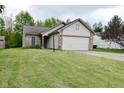 Charming one story home featuring a two car garage and a brick and vinyl facade at 5446 Lippan Way, Indianapolis, IN 46221