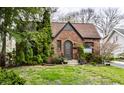 Charming brick home with landscaped front yard, stone pathway, and arched front door at 5683 Guilford Ave, Indianapolis, IN 46220
