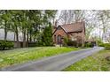 Charming brick home with paved driveway and landscaped front yard at 5683 Guilford Ave, Indianapolis, IN 46220