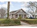 Craftsman home featuring a cozy front porch and mature landscaping at 6158 Ralston Ave, Indianapolis, IN 46220