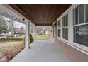 Inviting covered porch with stylish support columns and a stained wood ceiling at 6158 Ralston Ave, Indianapolis, IN 46220
